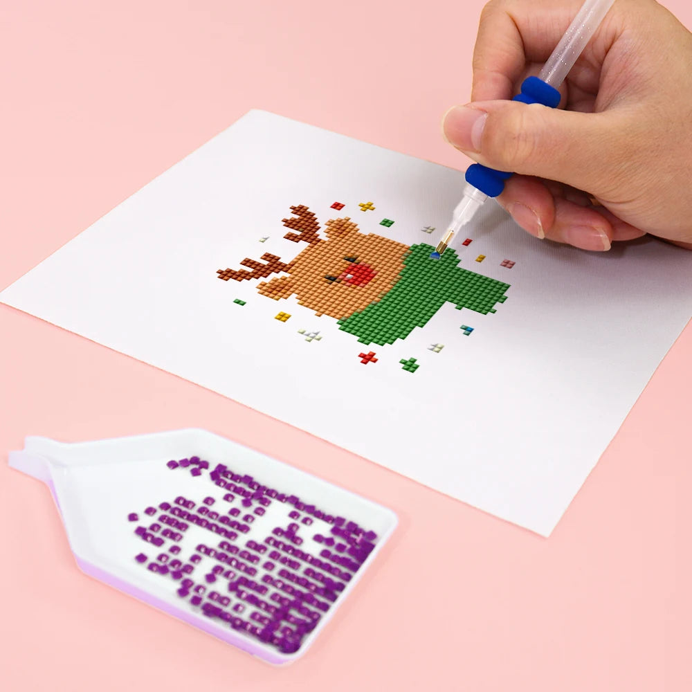 Close-up of drills being placed on a Classic Christmas Icons mini diamond painting design