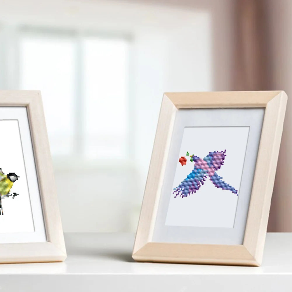 Completed Colourful Birds mini diamond painting shown as framed decor