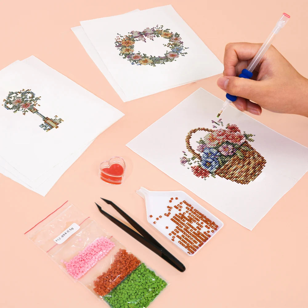 Working on several Floral Arrangements & Wreaths mini diamond painting designs with drills and applicator