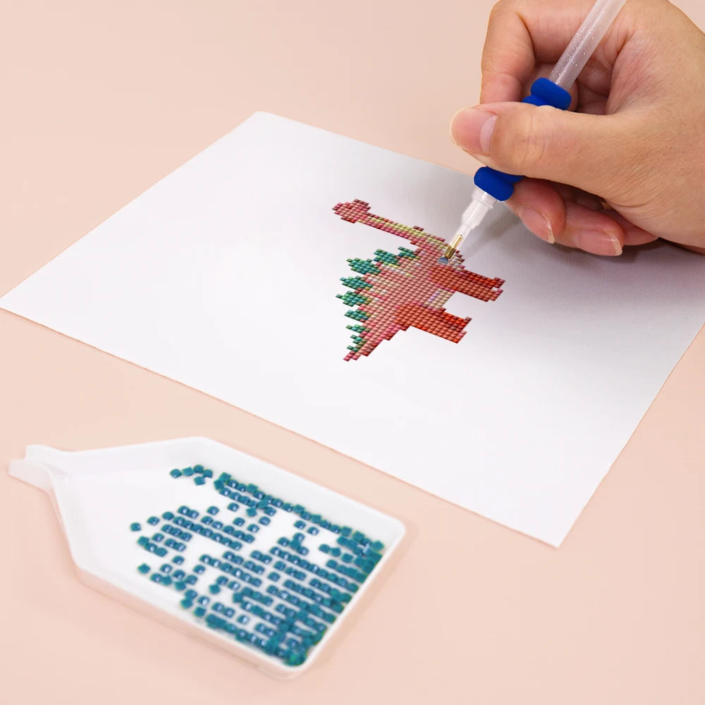 Close-up of drills being placed on a Playful Dinosaurs mini diamond painting design