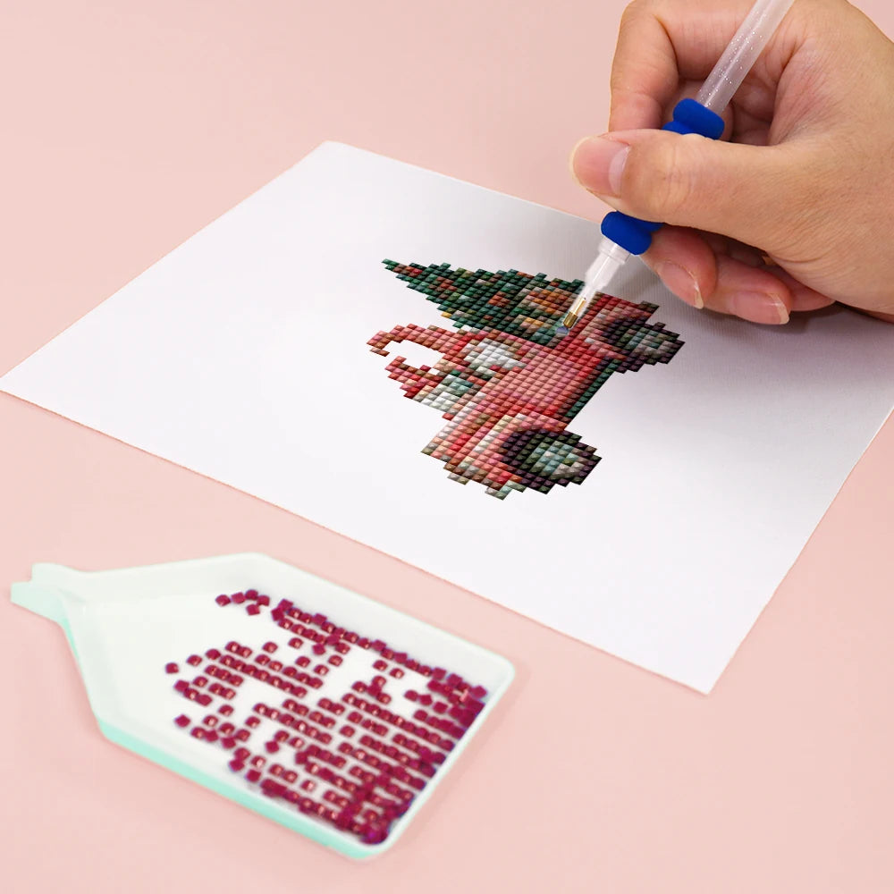 Close-up of drills being placed on a Vintage Christmas Village mini diamond painting design