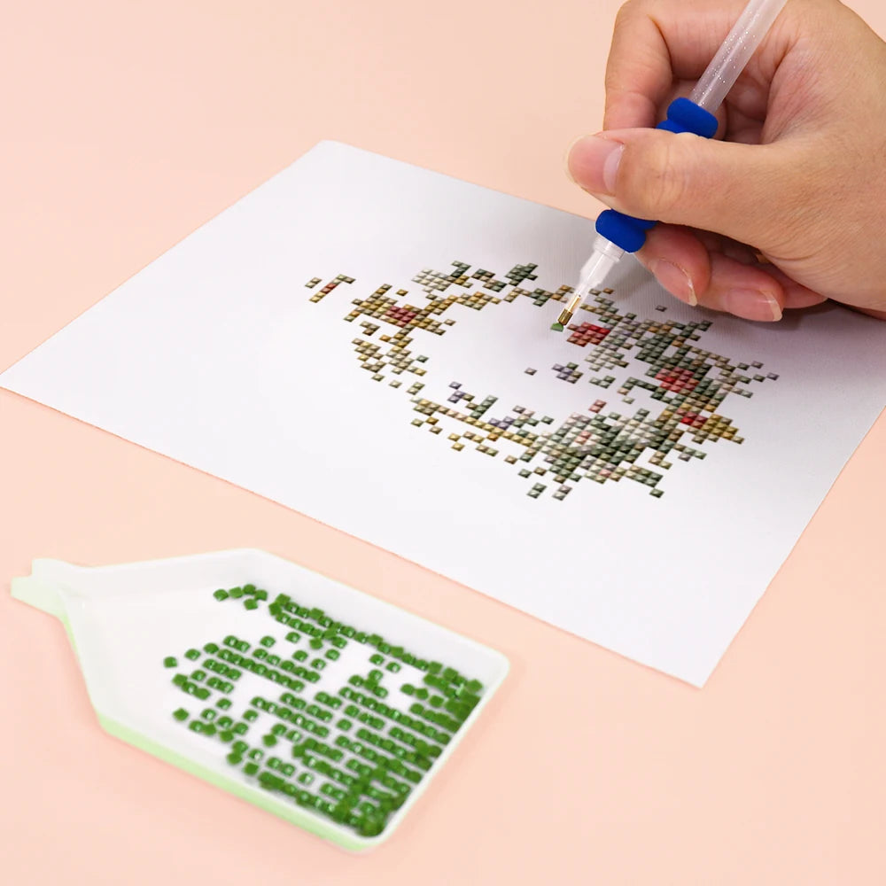 Close-up of drills being placed on a Vintage Floral Frames mini diamond painting design